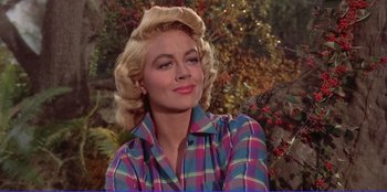 Movie still from “Written on the Wind” (1956), directed by Douglas Sirk – A woman with blonde hair wearing a plaid shirt; Close Up shot, Low angle