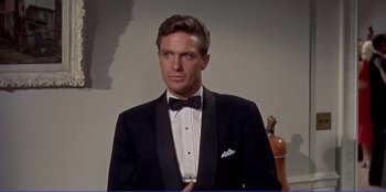 Movie still from “Written on the Wind” (1956), directed by Douglas Sirk – A man wearing a tuxedo and a bow tie; Close Up shot, Low angle