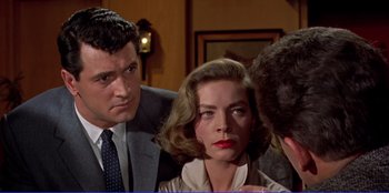 Movie still from “Written on the Wind” (1956), directed by Douglas Sirk – A man and a woman are talking to another man; Close Up shot, Over the shoulder angle