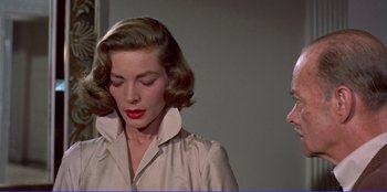 Movie still from “Written on the Wind” (1956), directed by Douglas Sirk – A person wearing a dress shirt; Close Up shot, Over the shoulder angle
