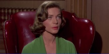 Movie still from “Written on the Wind” (1956), directed by Douglas Sirk – A woman in a green shirt sitting on a red chair; Close Up shot, Over the shoulder angle
