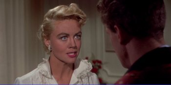 Movie still from “Written on the Wind” (1956), directed by Douglas Sirk – A man and a woman talking to each other; Close Up shot, Over the shoulder angle