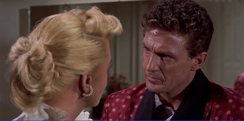 Movie still from “Written on the Wind” (1956), directed by Douglas Sirk – A man and a woman talking to each other; Close Up shot, Over the shoulder angle