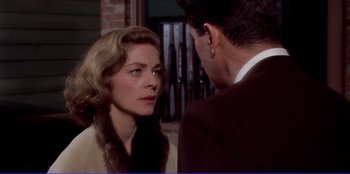 Movie still from “Written on the Wind” (1956), directed by Douglas Sirk – A man and a woman are standing next to each other; Close Up shot, Over the shoulder angle