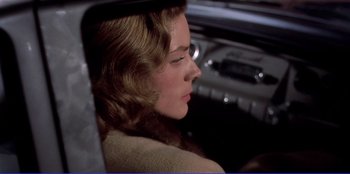 Movie still from “Written on the Wind” (1956), directed by Douglas Sirk – A woman sitting in the back seat of a car; Close Up shot, High angle
