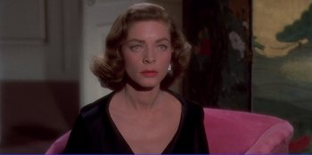 Movie still from “Written on the Wind” (1956), directed by Douglas Sirk – A person wearing a black shirt; Close Up shot, Over the shoulder angle