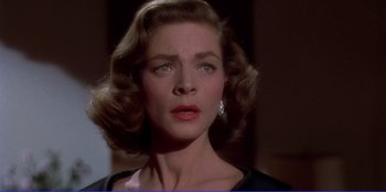 Movie still from “Written on the Wind” (1956), directed by Douglas Sirk – A person wearing a black dress; Close Up shot, Low angle