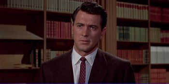 Movie still from “Written on the Wind” (1956), directed by Douglas Sirk – A person wearing a suit and tie; Close Up shot, Over the shoulder angle