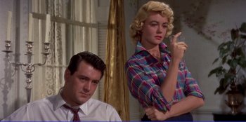Movie still from “Written on the Wind” (1956), directed by Douglas Sirk – A man and a woman in a plaid shirt; Medium shot, Low angle