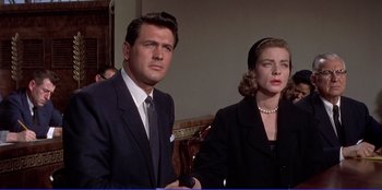 Movie still from “Written on the Wind” (1956), directed by Douglas Sirk – A man and a woman standing next to each other; Medium shot, Over the shoulder angle