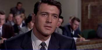 Movie still from “Written on the Wind” (1956), directed by Douglas Sirk – A person wearing a suit and tie; Close Up shot, Low angle