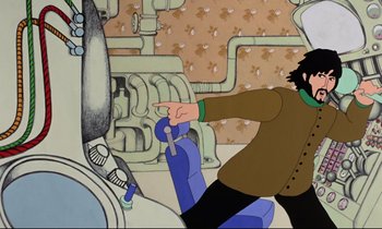 Movie still from “Yellow Submarine” (1968), directed by George Dunning – A man is pointing to something in a cartoon; Medium shot, Overhead angle