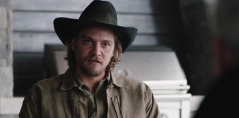 Movie still from “Yellowstone” (2018), created by John Linson – A person wearing a hat; Close Up shot, Over the shoulder angle