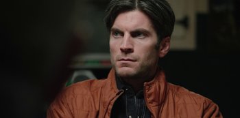 Movie still from “Yellowstone” (2018), created by John Linson – A person wearing a brown jacket; Close Up shot, Over the shoulder angle