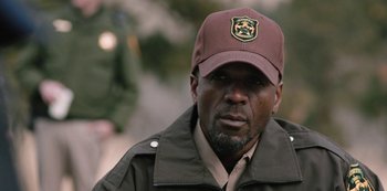 Movie still from “Yellowstone” (2018), created by John Linson – A person wearing a hat; Close Up shot, Over the shoulder angle
