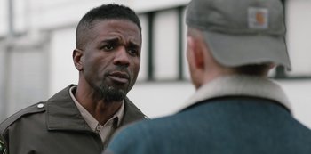 Movie still from “Yellowstone” (2018), created by John Linson – Two men are talking to each other outside; Close Up shot, Over the shoulder angle