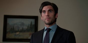 Movie still from “Yellowstone” (2018), created by John Linson – A man in a suit and a tie; Close Up shot, Over the shoulder angle