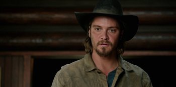 Movie still from “Yellowstone” (2018), created by John Linson – A person wearing a cowboy hat; Close Up shot, Over the shoulder angle
