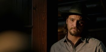 Movie still from “Yellowstone” (2018), created by John Linson – A person wearing a cowboy hat; Close Up shot, Low angle