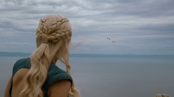 Movie still from “Game of Thrones” (2011), created by D.B. Weiss – A woman with long blonde hair looking out at the ocean; Close Up shot, Over the shoulder angle