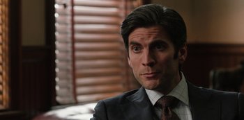 Movie still from “Yellowstone” (2018), created by John Linson – A man in a suit and a tie; Close Up shot, Over the shoulder angle