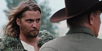 Movie still from “Yellowstone” (2018), created by John Linson – A person holding a bunch of wires; Close Up shot, Over the shoulder angle