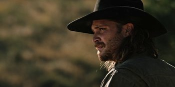 Movie still from “Yellowstone” (2018), created by John Linson – A person wearing a hat; Close Up shot, Over the shoulder angle