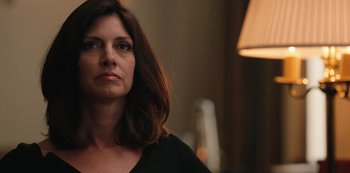 Movie still from “Yellowstone” (2018), created by John Linson – A person wearing a black shirt; Close Up shot, Over the shoulder angle