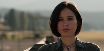 Movie still from “Yellowstone” (2018), created by John Linson – A person wearing a necklace; Close Up shot, Low angle