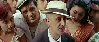 Movie still from “Yesterday, Today and Tomorrow” (1963), directed by Vittorio De Sica – An older man wearing a white hat and a tie; Close Up shot, Over the shoulder angle