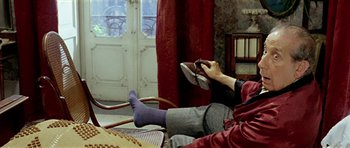 A person sitting on a chair holding a pair of shoes