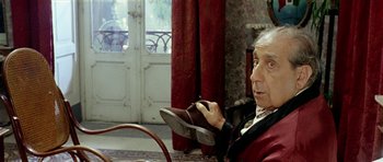 Movie still from “Yesterday, Today and Tomorrow” (1963), directed by Vittorio De Sica – An older man holding a pair of shoes in his hand; Close Up shot, Low angle