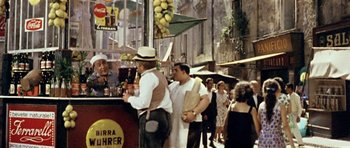 Movie still from “Yesterday, Today and Tomorrow” (1963), directed by Vittorio De Sica – A group of people standing on a sidewalk; Wide shot, High angle