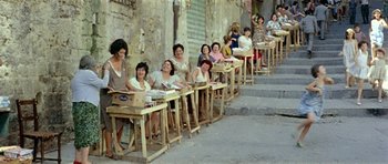 Movie still from “Yesterday, Today and Tomorrow” (1963), directed by Vittorio De Sica – A group of women sitting at a table on a sidewalk; Wide shot, High angle