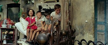 Movie still from “Yesterday, Today and Tomorrow” (1963), directed by Vittorio De Sica – A group of children sitting on top of a bed; Wide shot, High angle