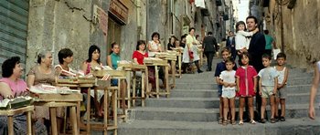 Movie still from “Yesterday, Today and Tomorrow” (1963), directed by Vittorio De Sica – A group of people sitting at tables outside of a restaurant; Wide shot, High angle