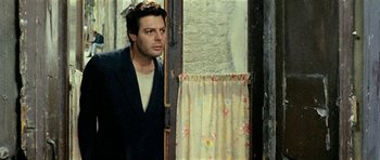 Movie still from “Yesterday, Today and Tomorrow” (1963), directed by Vittorio De Sica – A man standing in front of an open door; Medium shot, Low angle