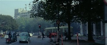 Movie still from “Yesterday, Today and Tomorrow” (1963), directed by Vittorio De Sica – People are walking on the sidewalk near a street light; Extreme Wide shot, High angle
