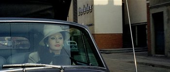 Movie still from “Yesterday, Today and Tomorrow” (1963), directed by Vittorio De Sica – A woman sitting in the passenger's seat of a car; Close Up shot, Over the shoulder angle