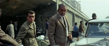 Movie still from “Yesterday, Today and Tomorrow” (1963), directed by Vittorio De Sica – A man in a suit and tie standing next to another man in a suit and tie; Medium shot, Low angle