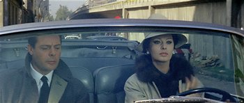 Movie still from “Yesterday, Today and Tomorrow” (1963), directed by Vittorio De Sica – A woman sitting in the back seat of a car; Medium shot, High angle