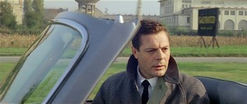 Movie still from “Yesterday, Today and Tomorrow” (1963), directed by Vittorio De Sica – A man standing in front of an airplane wing; Close Up shot, Over the shoulder angle