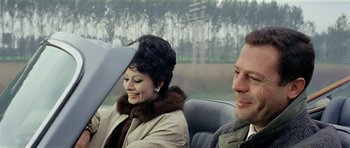 Movie still from “Yesterday, Today and Tomorrow” (1963), directed by Vittorio De Sica – A man and a woman sitting in the back of a car; Close Up shot, Over the shoulder angle