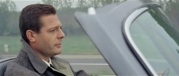Movie still from “Yesterday, Today and Tomorrow” (1963), directed by Vittorio De Sica – A man sitting in the driver's seat of a car; Close Up shot, Over the shoulder angle