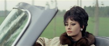 Movie still from “Yesterday, Today and Tomorrow” (1963), directed by Vittorio De Sica – A person wearing a coat; Close Up shot, Over the shoulder angle
