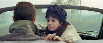 Movie still from “Yesterday, Today and Tomorrow” (1963), directed by Vittorio De Sica – A woman sitting next to a man in a car; Close Up shot, Over the shoulder angle