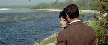 Movie still from “Yesterday, Today and Tomorrow” (1963), directed by Vittorio De Sica – A man and a woman standing next to a body of water; Medium shot, Over the shoulder angle
