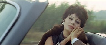 Movie still from “Yesterday, Today and Tomorrow” (1963), directed by Vittorio De Sica – A woman sitting in the back seat of a car; Close Up shot, High angle