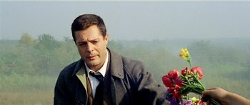 Movie still from “Yesterday, Today and Tomorrow” (1963), directed by Vittorio De Sica – A man in a suit and tie holding a flower; Close Up shot, Low angle