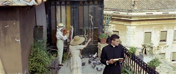 Movie still from “Yesterday, Today and Tomorrow” (1963), directed by Vittorio De Sica – A group of people standing next to each other on a porch; Wide shot, Low angle